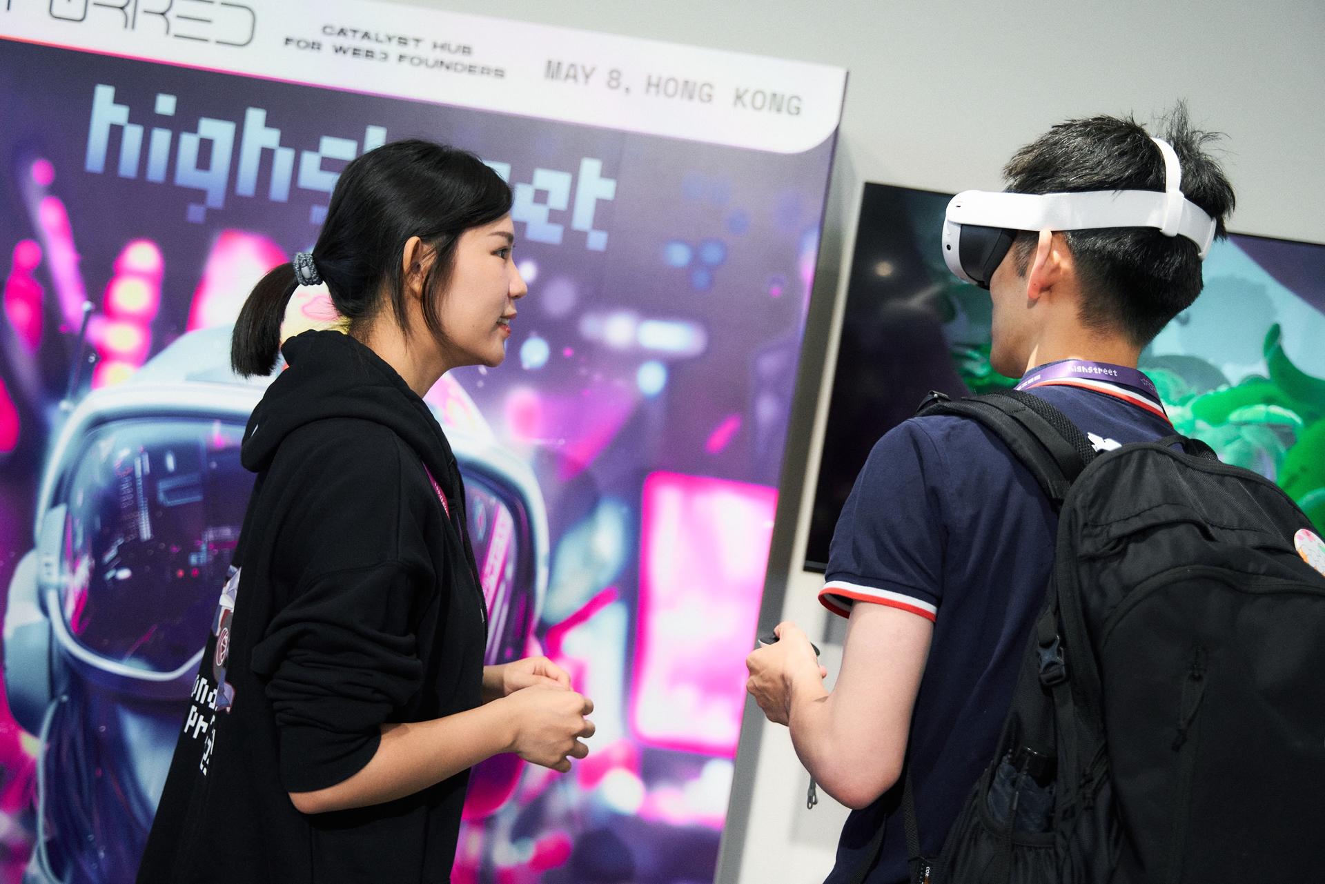 team member helping visitors in a VR demostration